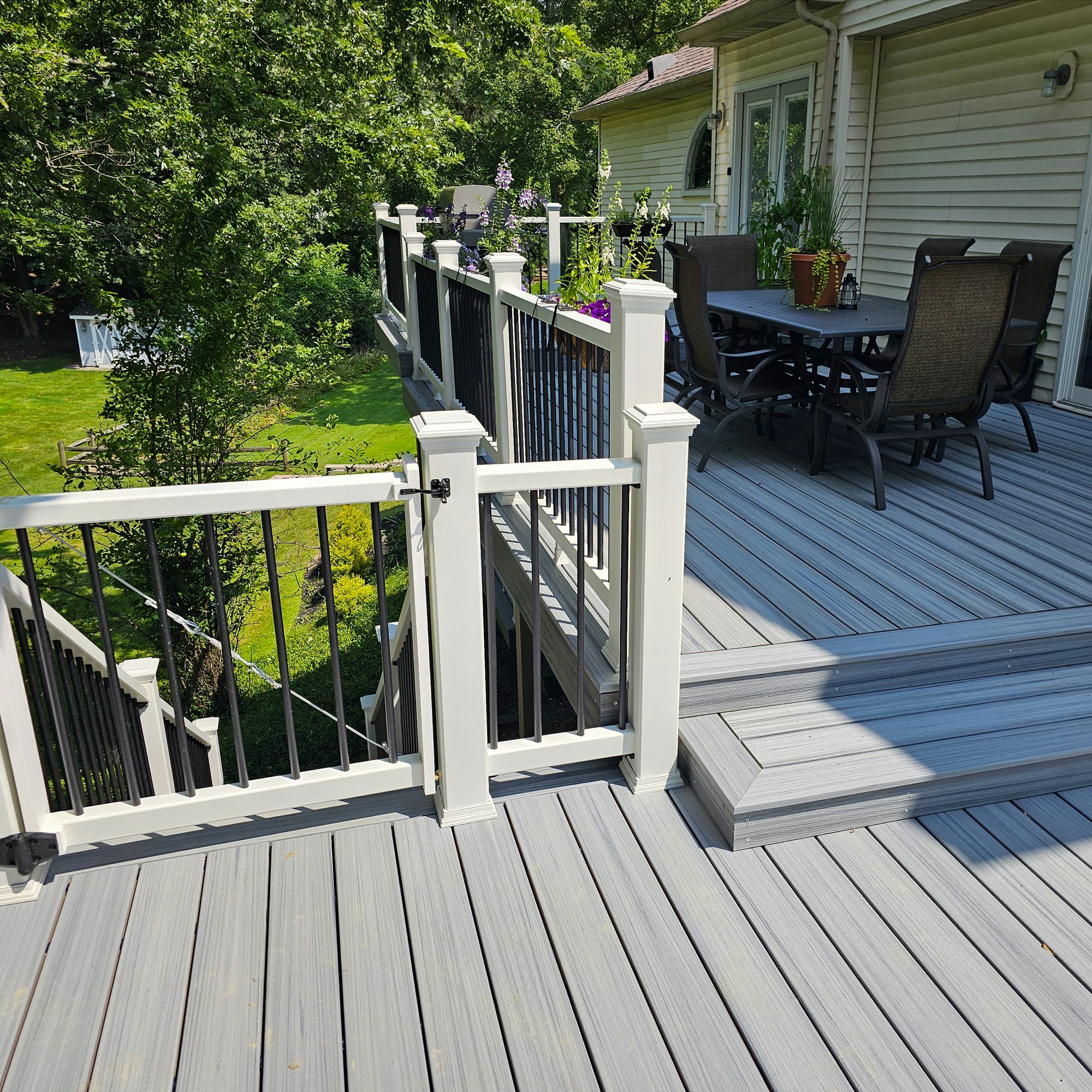 New backyard deck addition with black metal railing