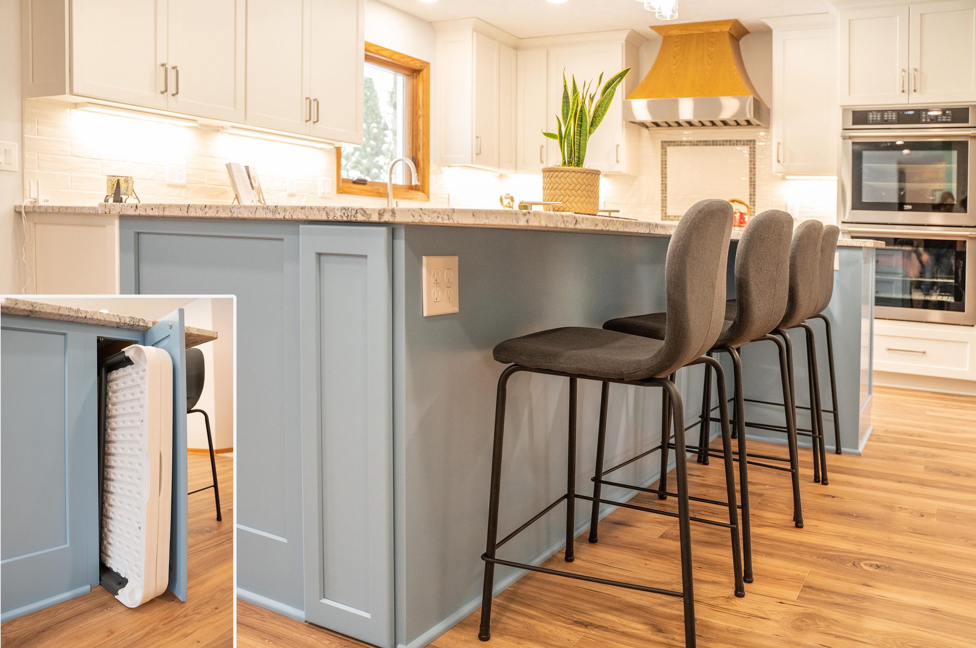Kitchen remodel with a navy-blue island, bar seating and white cabinetry