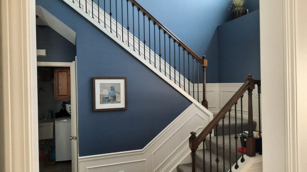 Staircase remodel with a navy accent wall